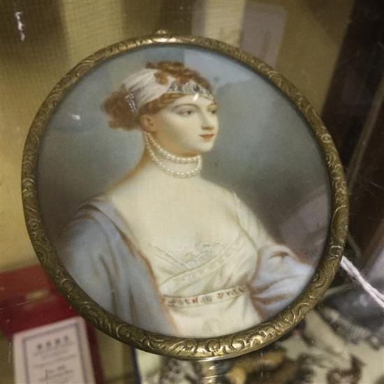 Oval miniature portrait of a young lady wearing pearls and jewelled headdress, signed initials, gilt metal frame